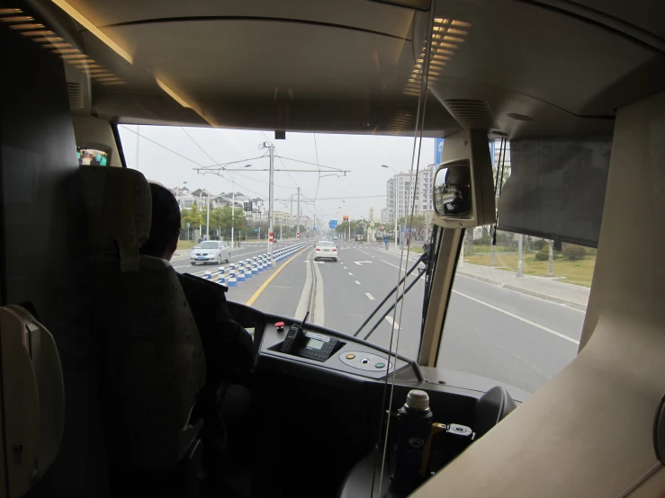 view of highway from inside the bus going to somewhere