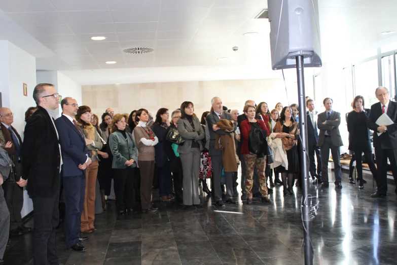 a crowd of people standing in a large building