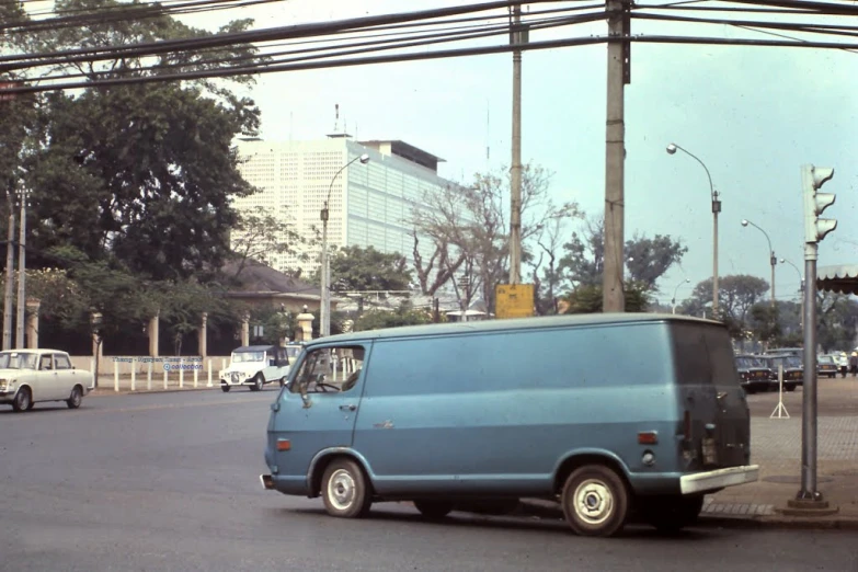 an old po of the blue van parked at a street corner