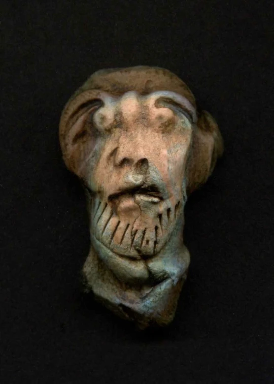 the head of an ancient statue with no teeth