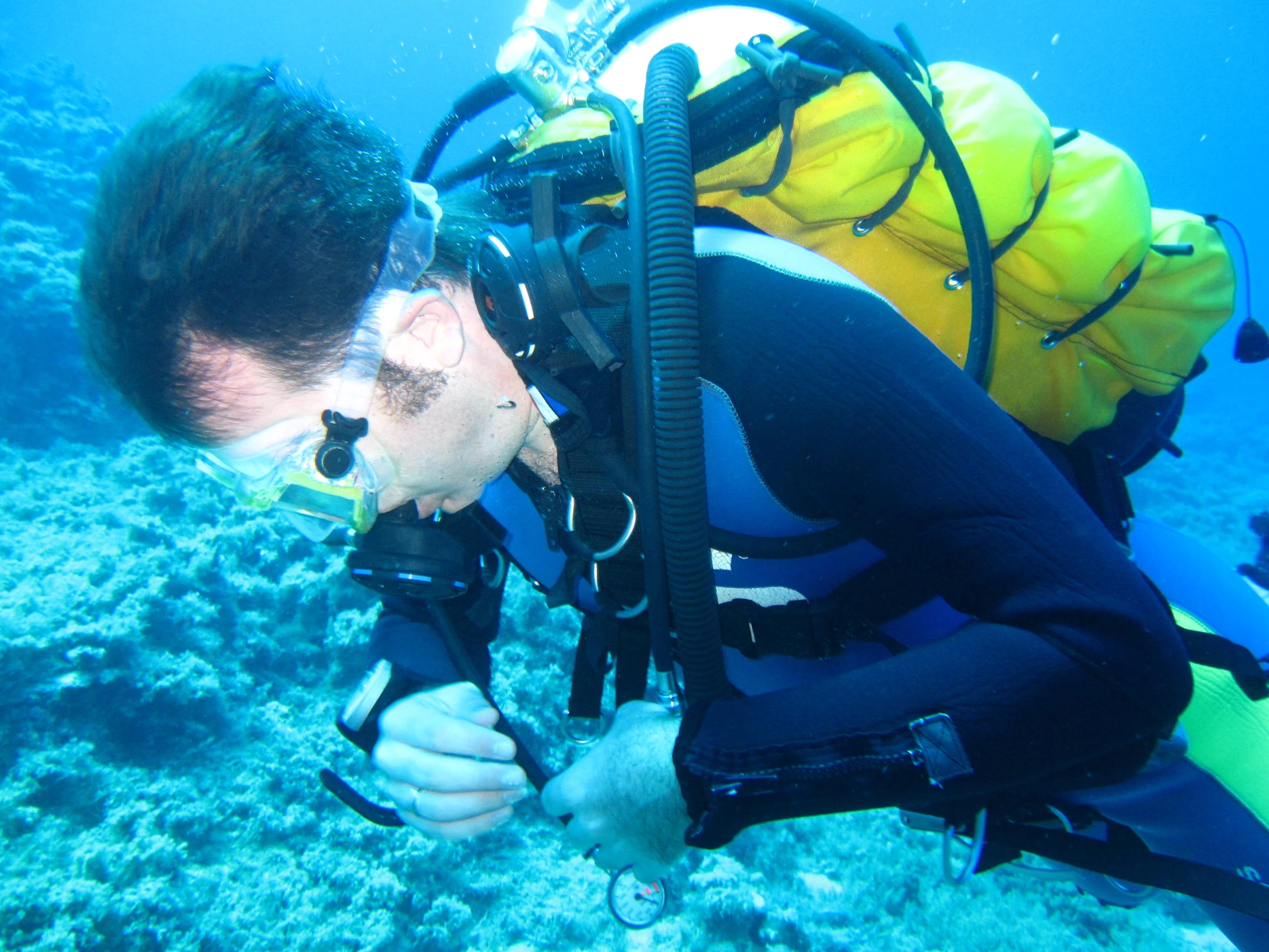 the man in black is diving with some equipment