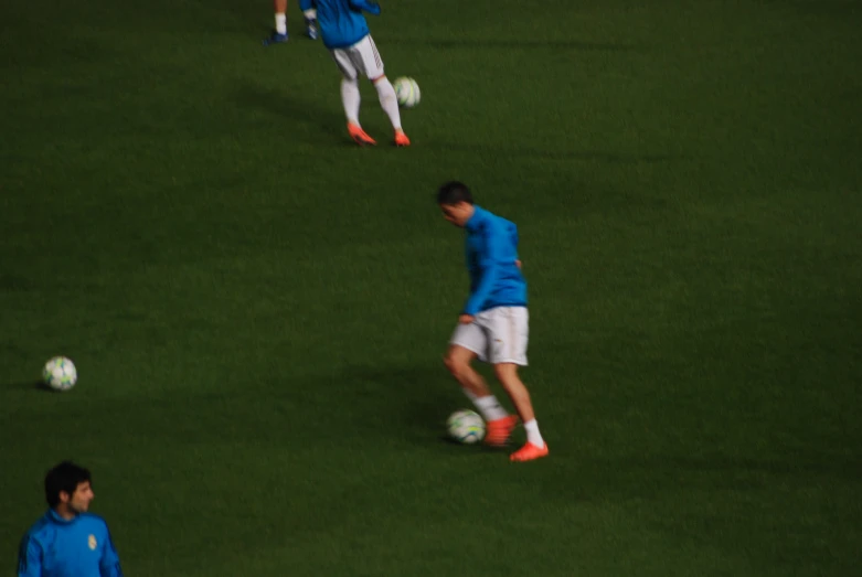 a group of soccer players playing on grass