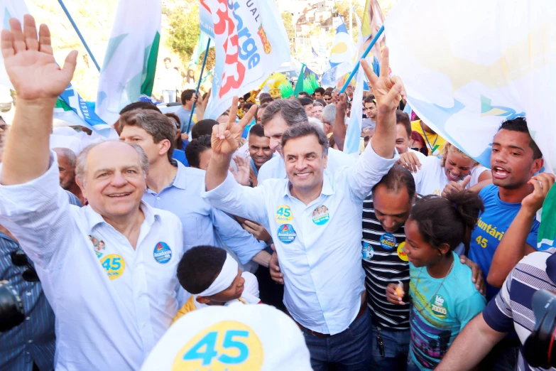 many people are holding flags and posing for the camera