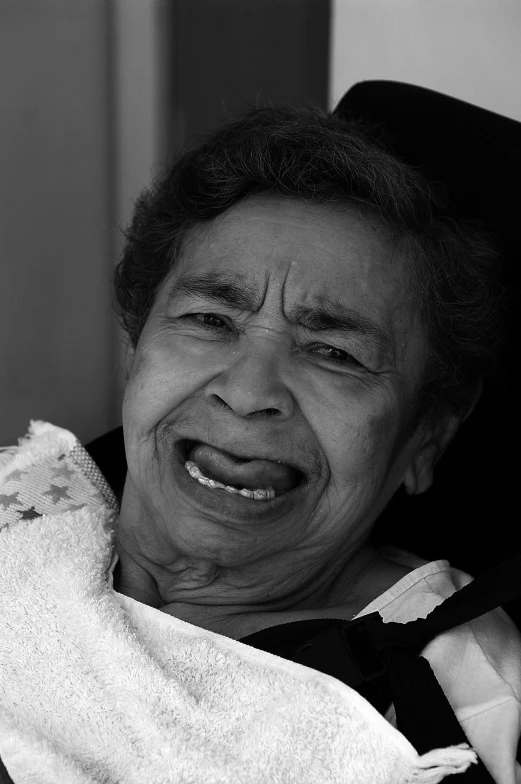 an elderly woman laughs in a stroller