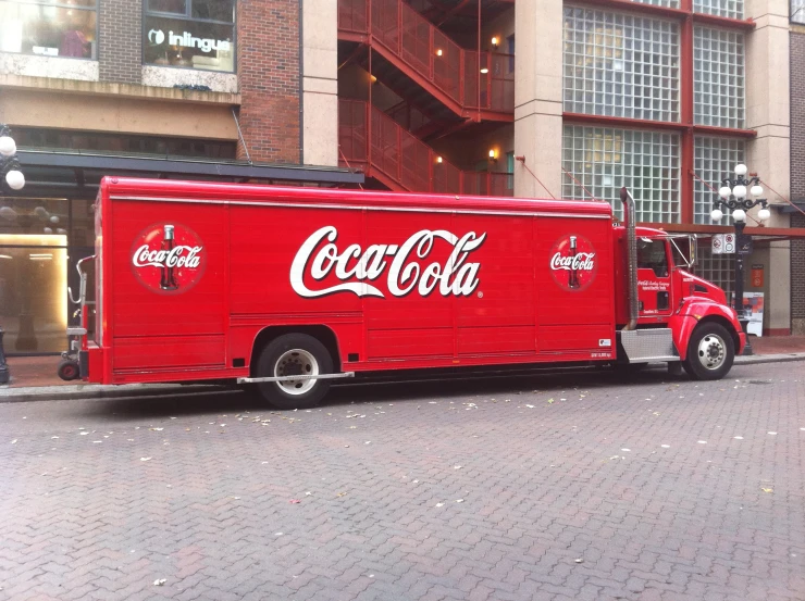 a coke truck sitting in front of a store