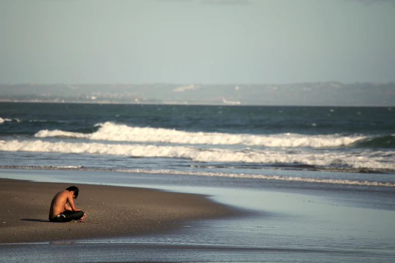 a person sitting on top of the beach