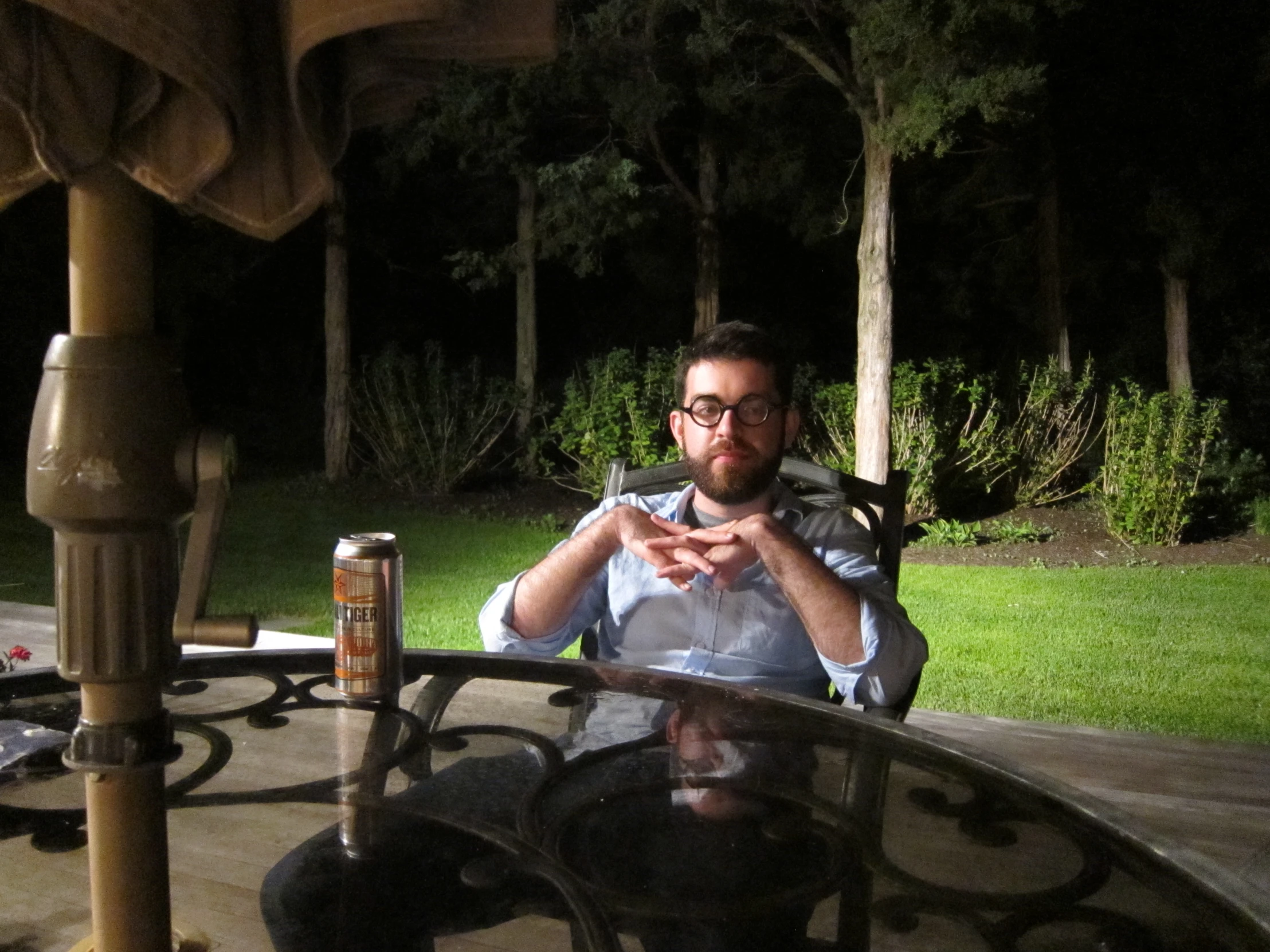 man sitting at table outdoors in the evening