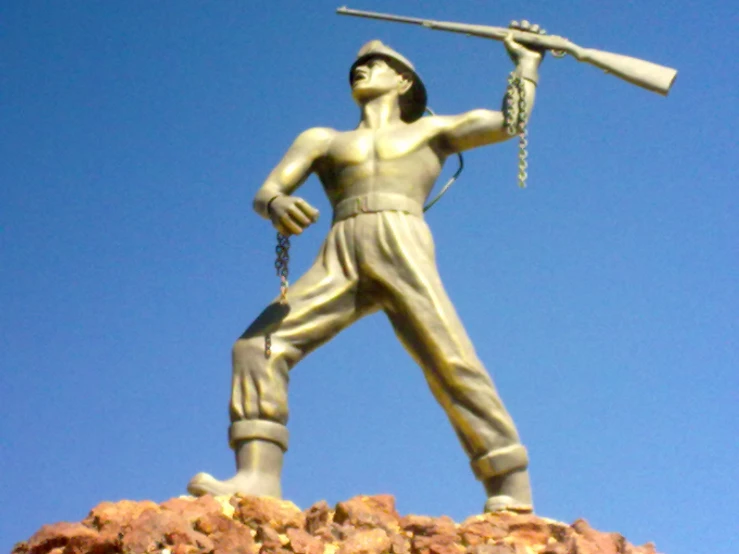 a statue of a man holding a rifle