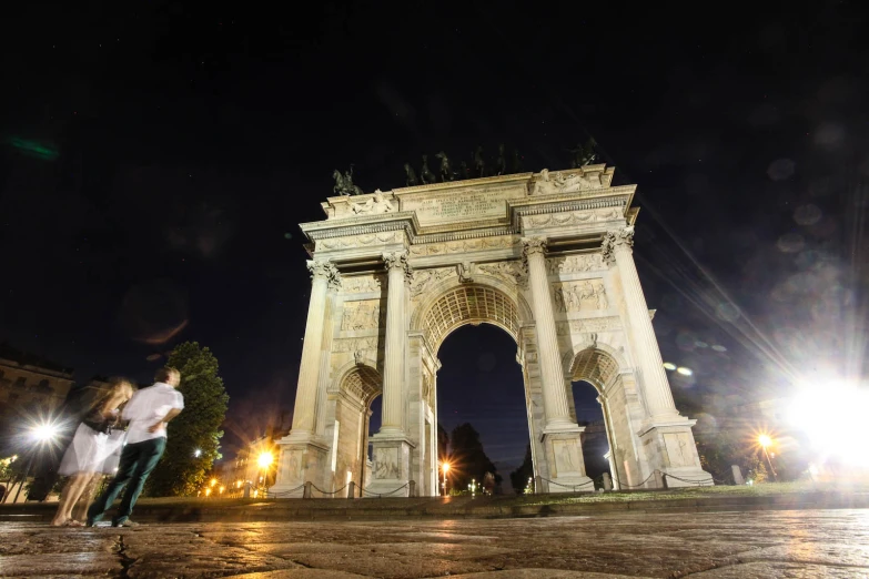 two people are on top of the triumph gate in a city