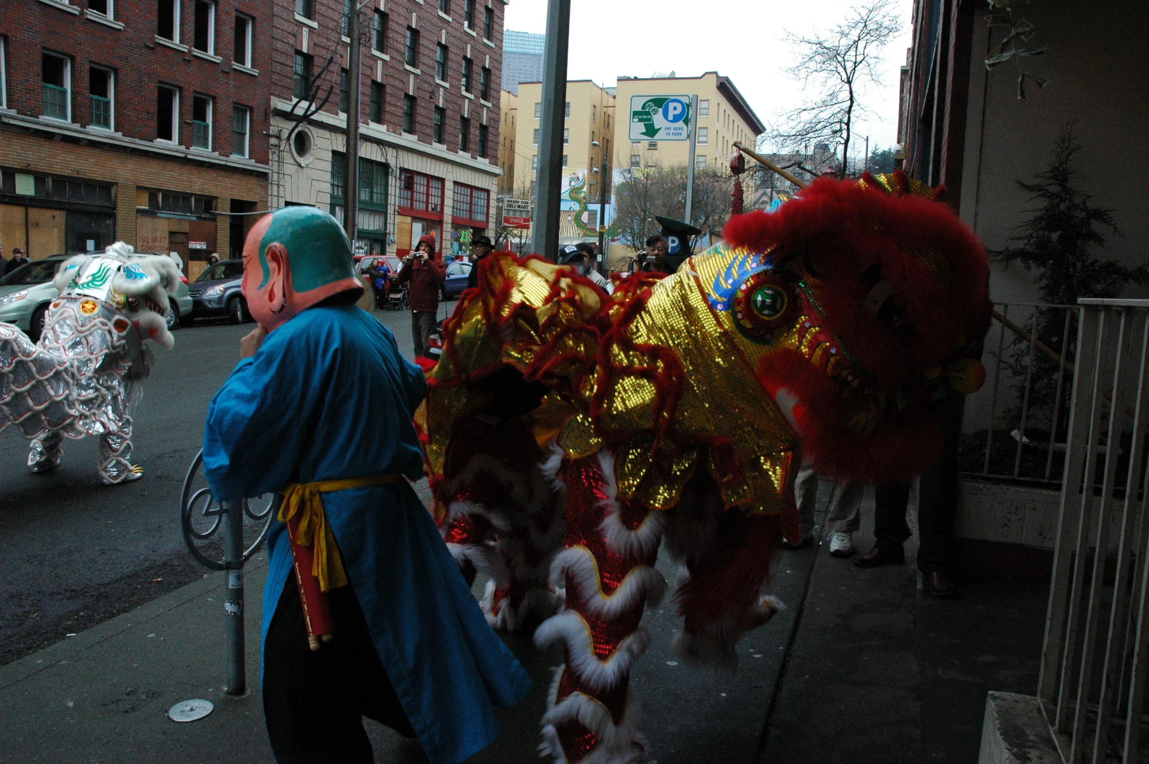 a man walking with an asian dragon and lion costume