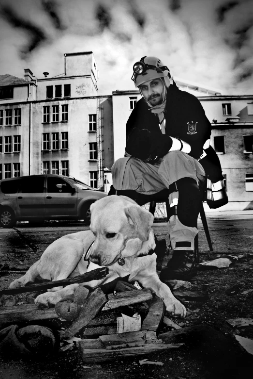 a man with his dog is squatting down