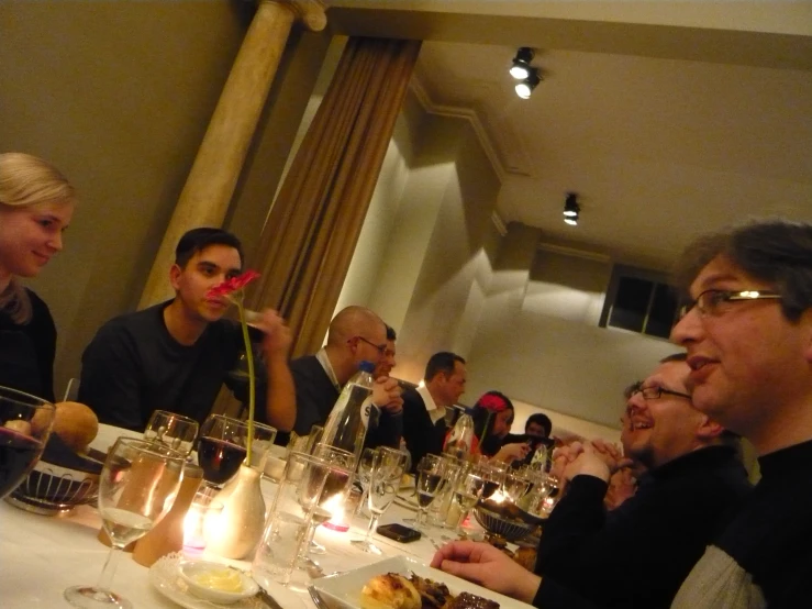 a group of people sitting around a dinner table