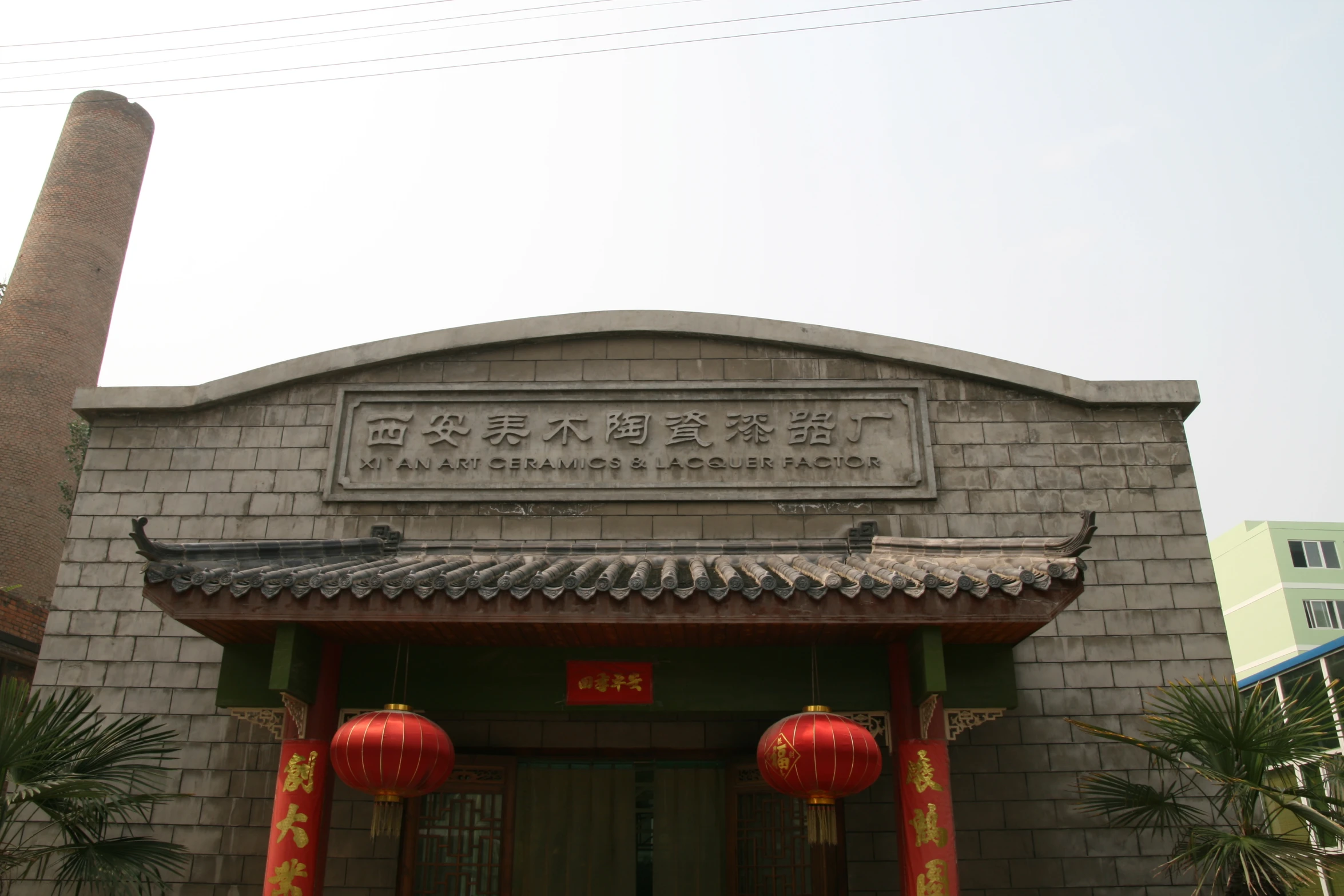 the front entrance of a chinese building with a brick wall