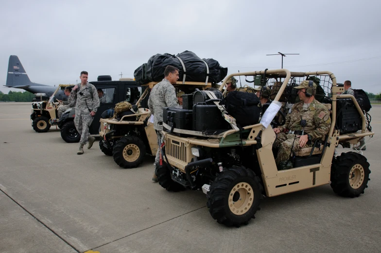 military personnel on land vehicles parked at airport