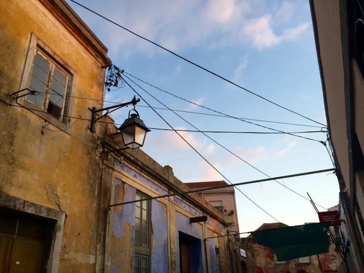 an alley way with a street light and buildings