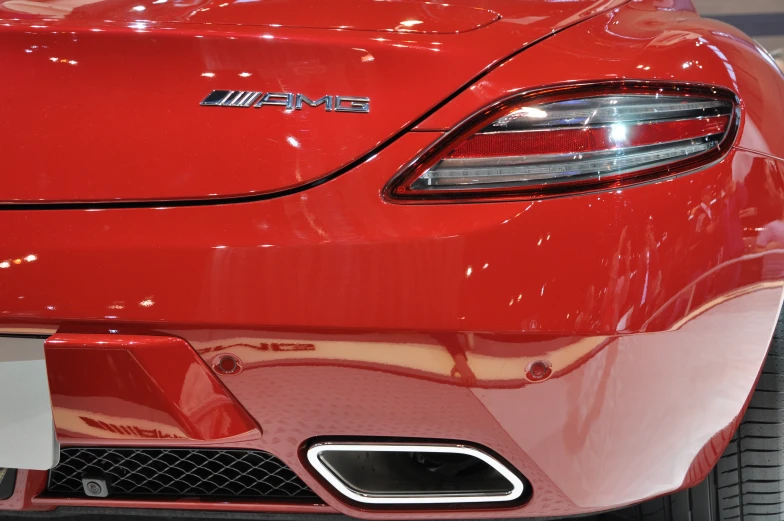a close up view of the tail light of a red sports car