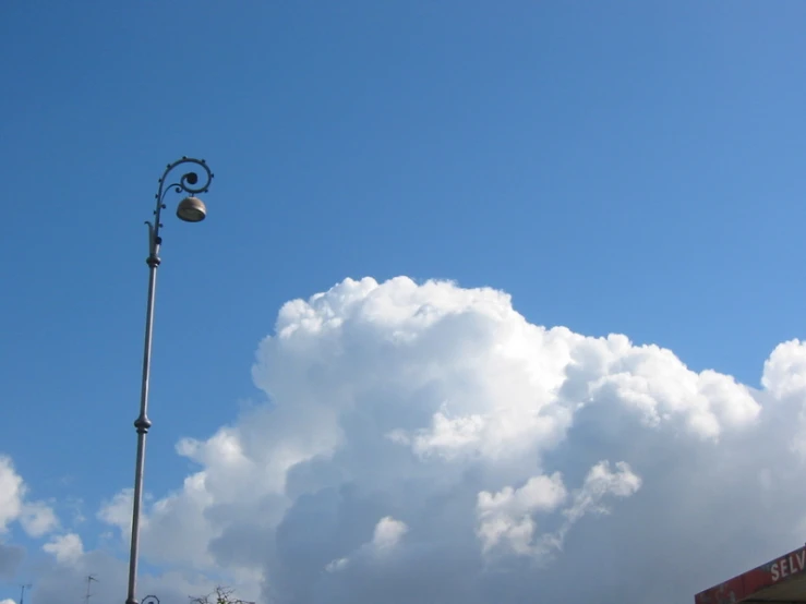 a street light near a cloudy sky