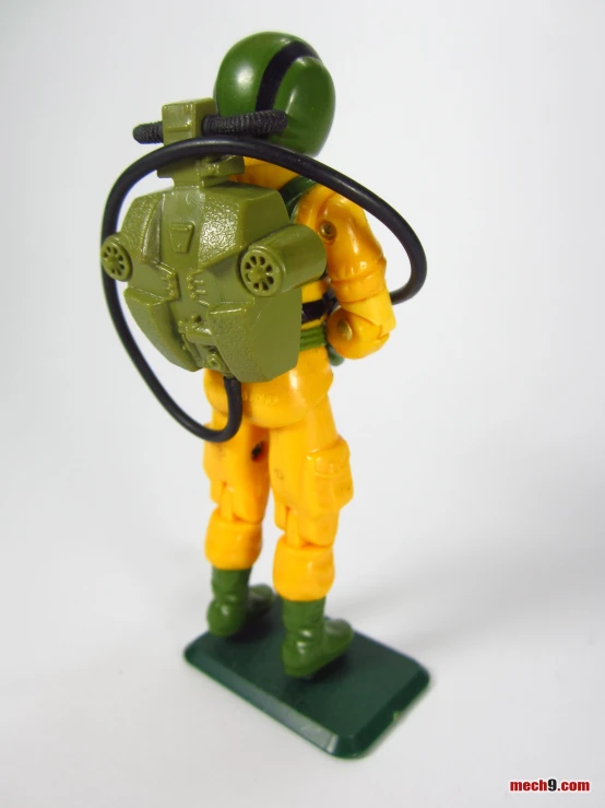 there is a green and yellow figurine holding a hose