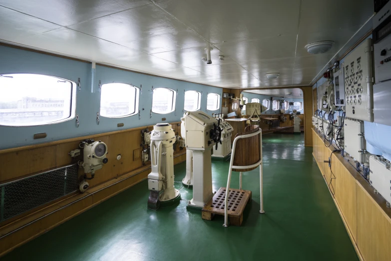 large ship with multiple instruments on the wall and the steering wheel visible