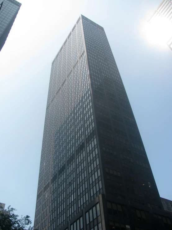 a very tall building towering above a couple of other buildings