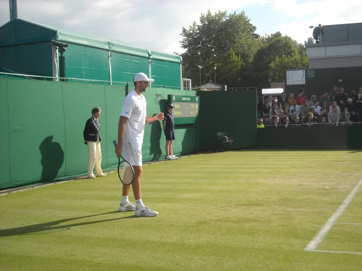 a man playing tennis is getting ready to hit the ball