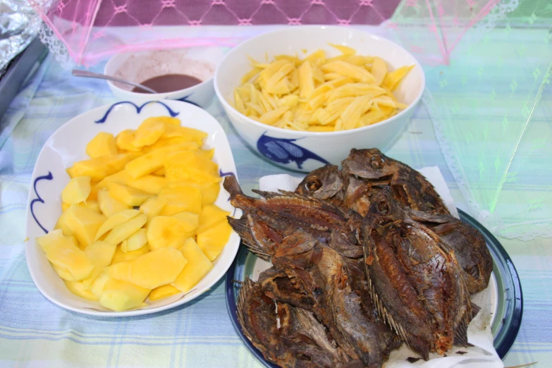 the three bowls have various foods on them