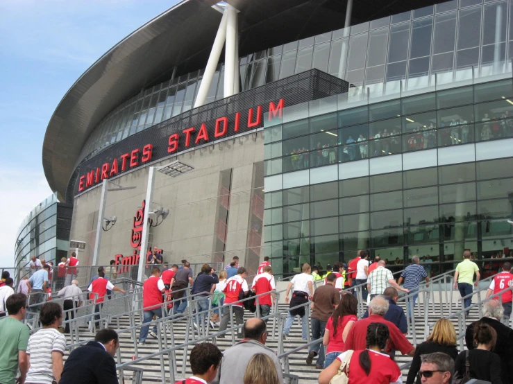 a crowd of people walking into an empty stadium