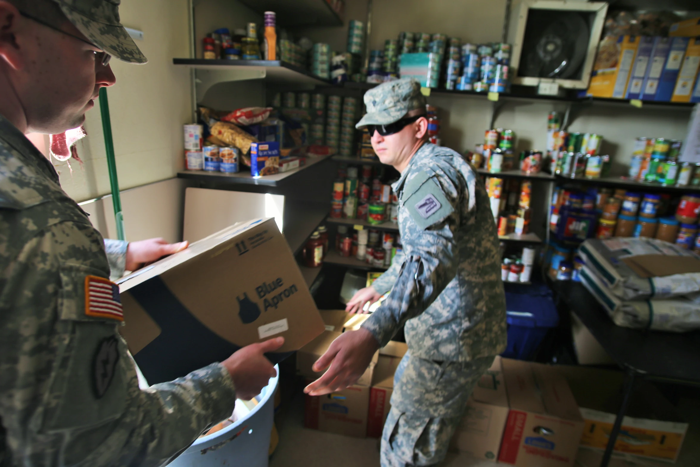 two soldiers work together in a store selling goods