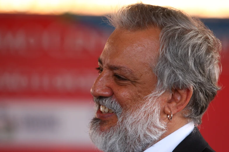 an older man with a beard and mustache smiling