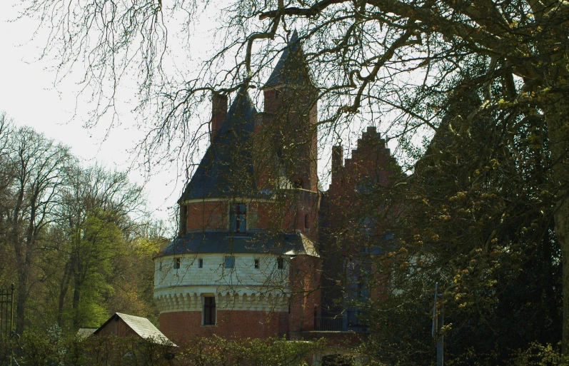 a po of a castle like structure with trees in the foreground
