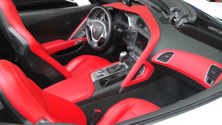 the interior of a sports car that has a black and red leather finish