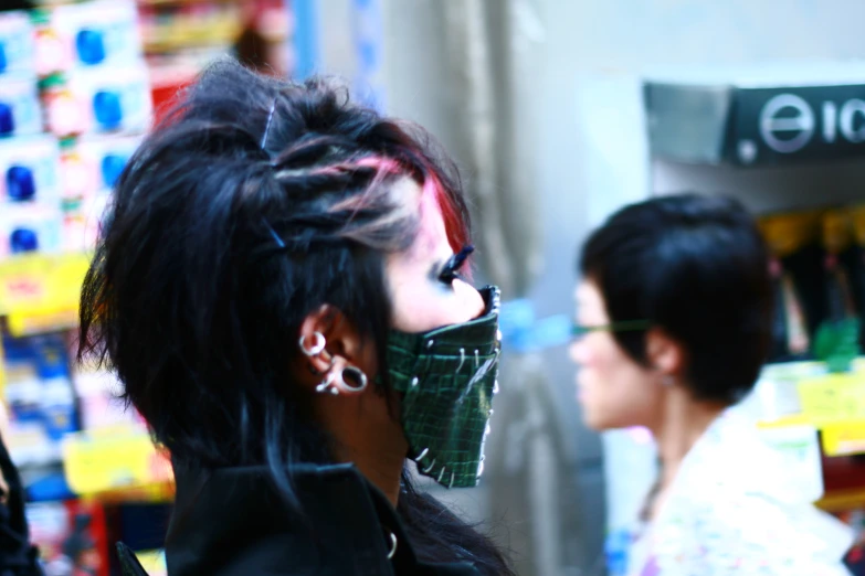 woman with black hair wearing a surgical mask