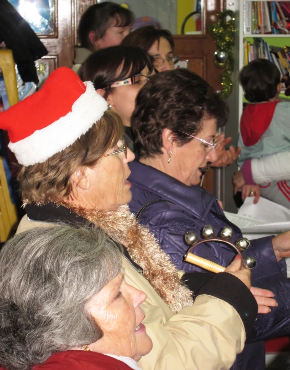 group of elderly people dressed up in christmas hats