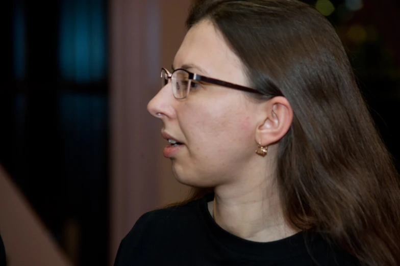 a woman with glasses and a black shirt