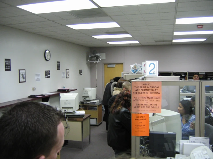 a group of people standing in an office