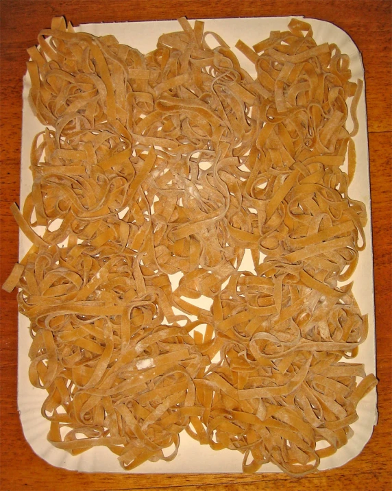 a bunch of noodles are being cooked on a plate