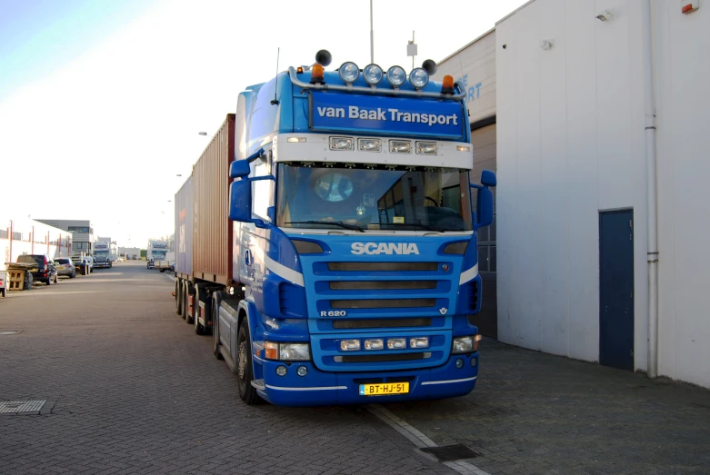 a truck is parked by the building in front of it