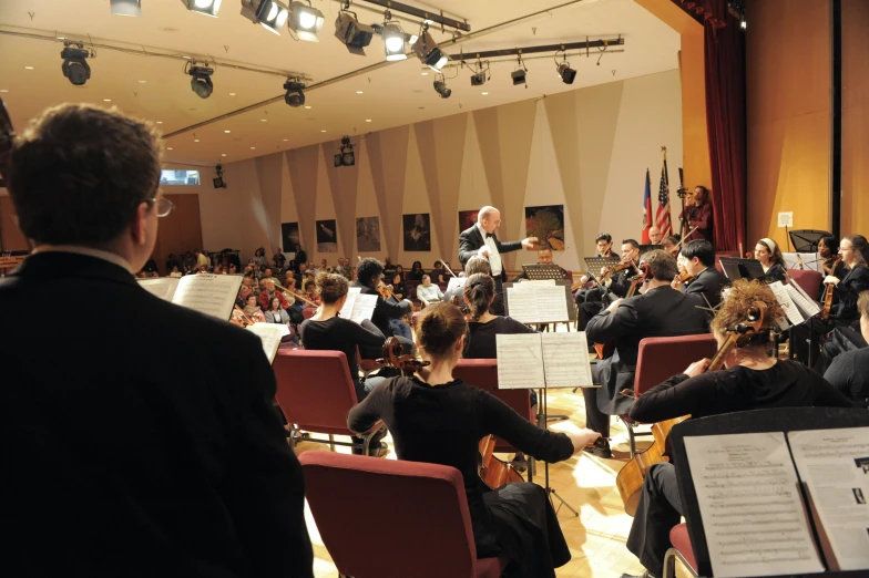 a conductor is playing music with an audience