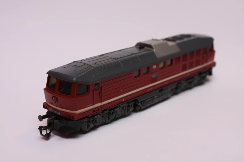 an old model train that is red and black