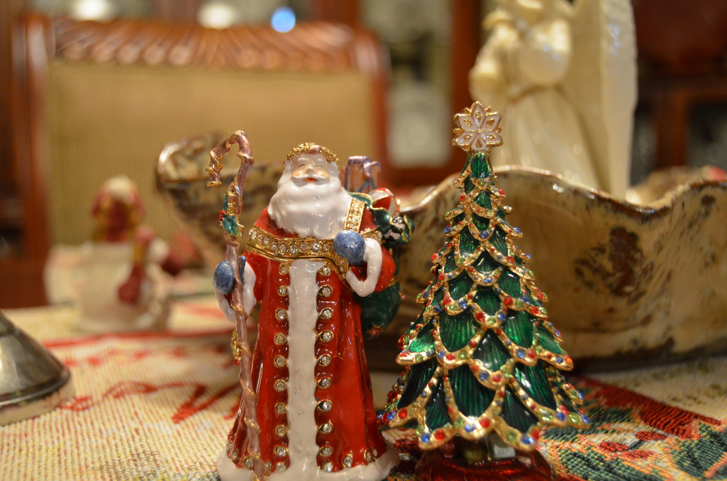 a santa clause figurine next to a christmas tree