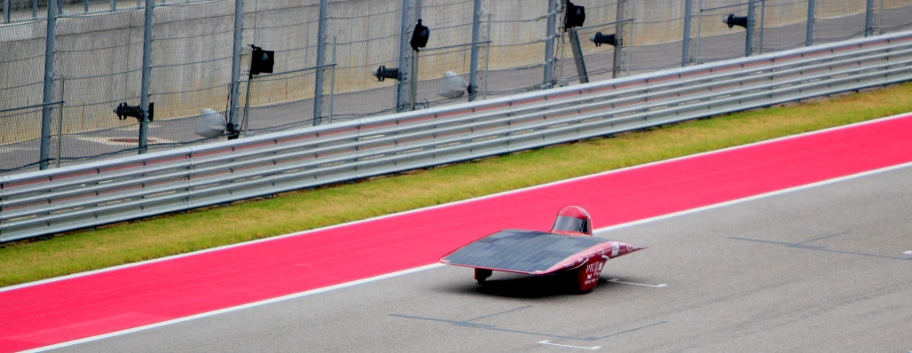 a racing car drives down a track with a pad