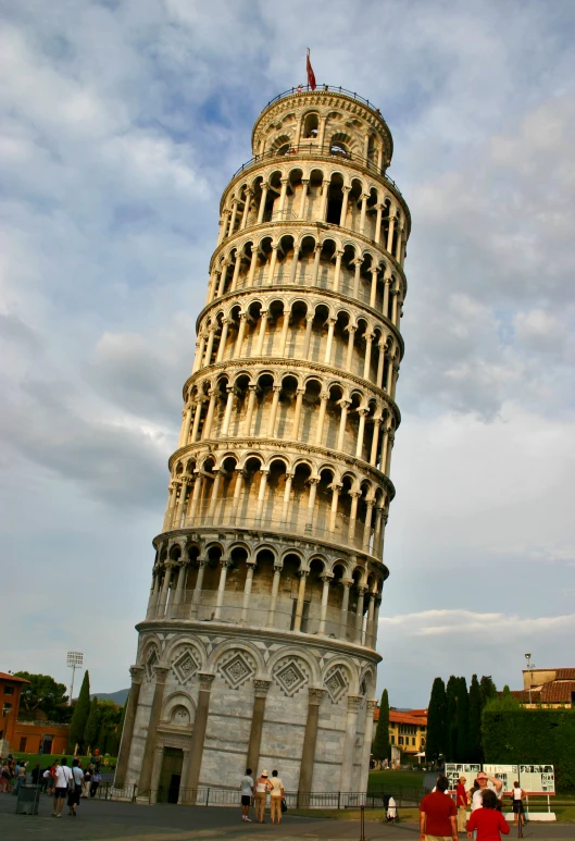 people sitting around a big, stone monument