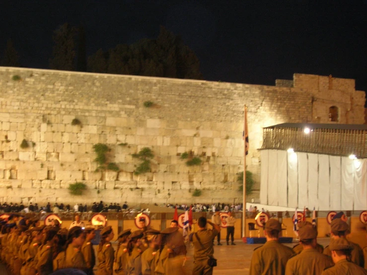 some people in military uniforms standing around talking