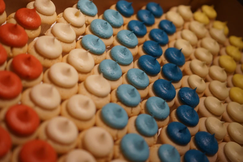 some cupcakes decorated with many colored frosting