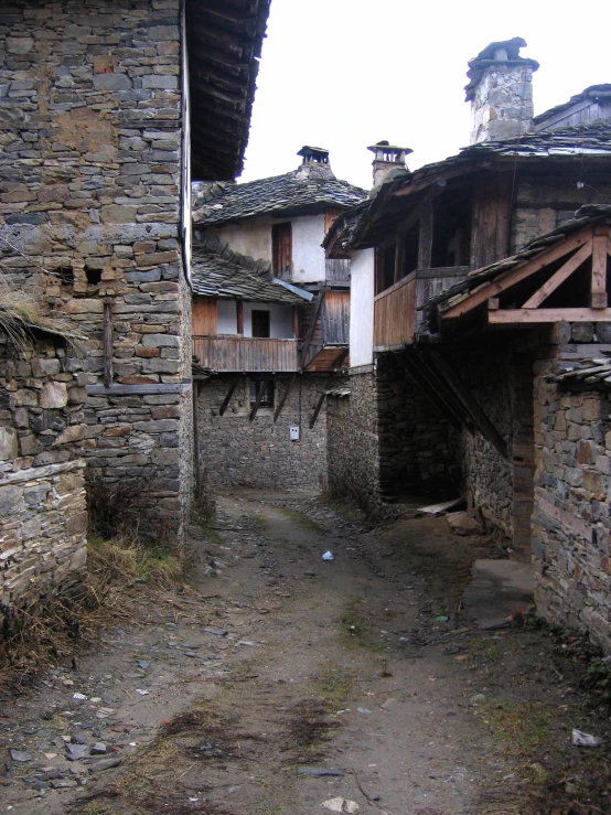 an alley way with stone and wood buildings