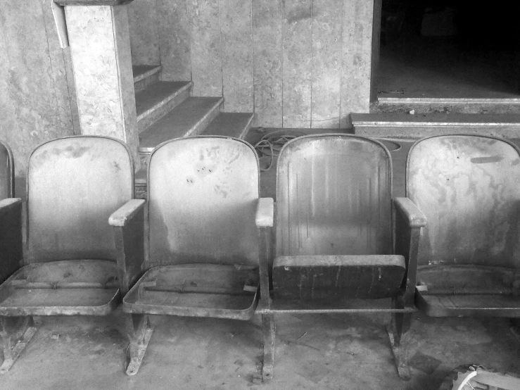 three rows of empty chairs in the middle of a room