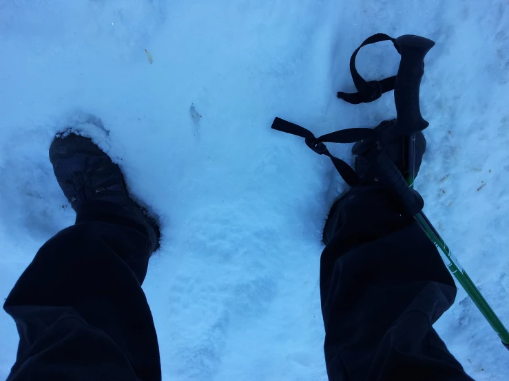 a person standing in the snow with their skis attached