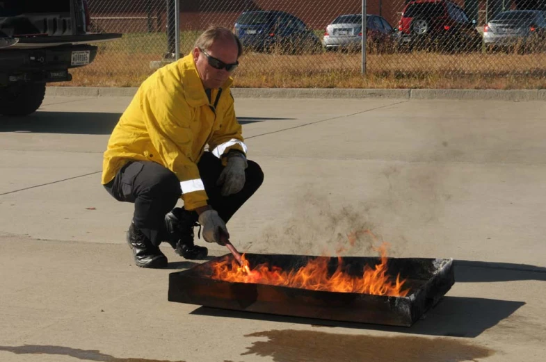 a man in yellow jacket and safety goggles