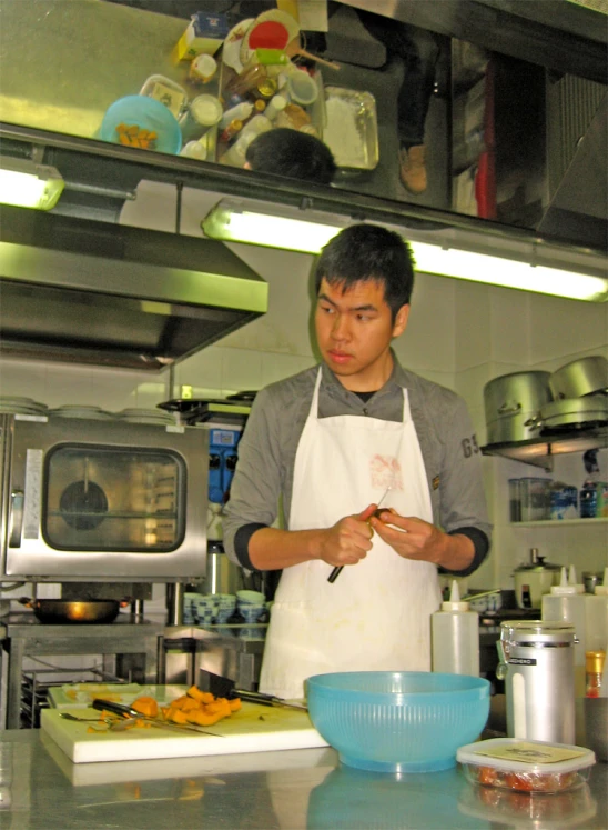 a man in an industrial kitchen cooking food