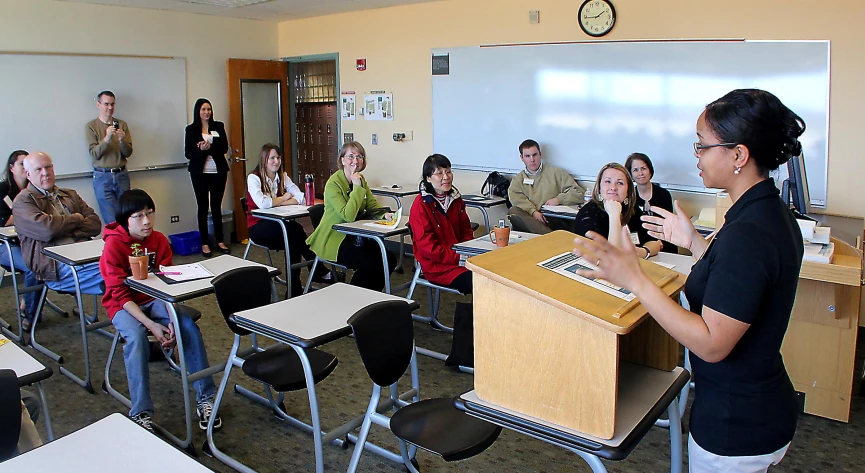 group of people in class rooms using electronic devices